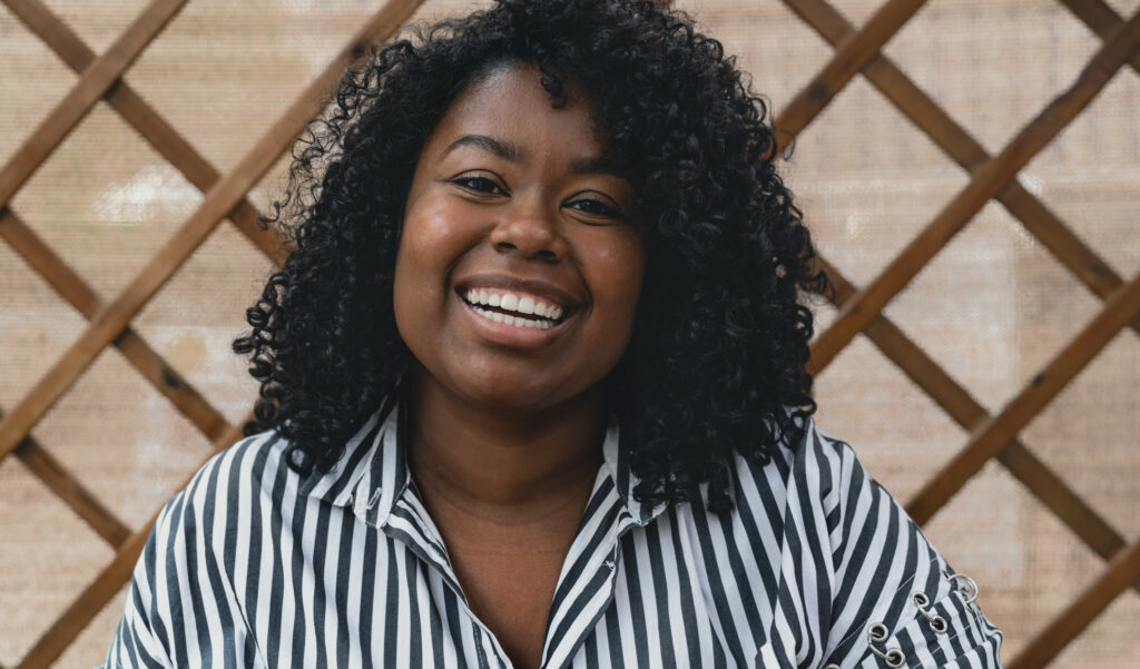 portrait-of-smiling-african-woman-during-corona-vi-2022-02-22-14-08-53-utc.jpg
